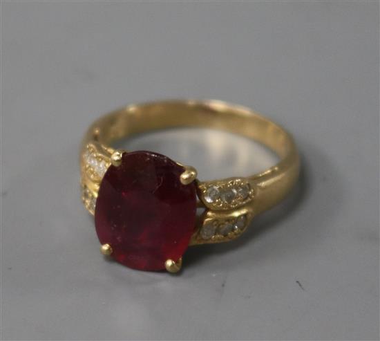 A modern 14ct gold ruby and diamond set dress ring, size O.